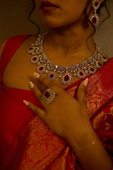 Close-up of pink Purvi Diamante Necklace Set - Bridal Indian Jewelry worn with red saree, showcasing intricate bridal craftsmanship.