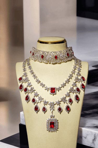 Priya Diamante Bridal Set - Rhodium-plated silver with maroon accents, including cascading necklace and intricate floral choker with matching earrings.
