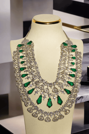 Ashma Bridal Set - Multilayer rhodium-plated silver finish with emerald green stones, including choker and multi-layered necklace.