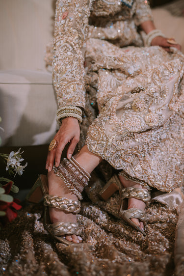Soha artisan crafted bridal statement ankle set for Desi brides in antique gold and pearl with white stones