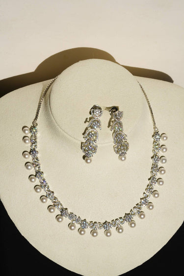 Aditi Flora Pearl & Diamante Necklace Set on display bust