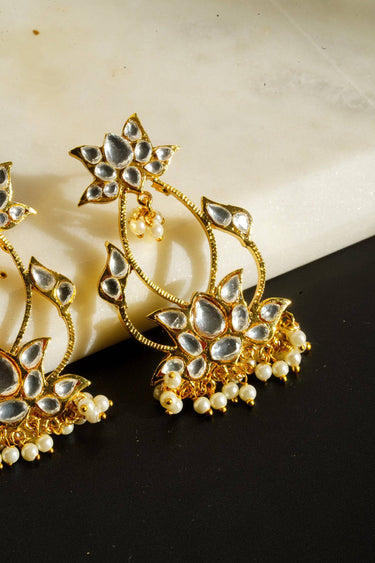 Intricate Kundan earrings with lotus design and pearl accents