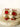 Sweta Choker Set earrings with red doublet stones and kundan accents, displayed on marble for a luxurious jewelry look.