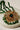Close-up of Ira - Chandbali pendant in green bead variant, featuring gold-tone craftsmanship and green crystal bead fringe.