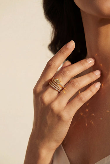 Model wearing the Inaury Nina multirow adjustable AD ring in gold plating with white diamante stones and cushion cut center stone – South Asian jewelry