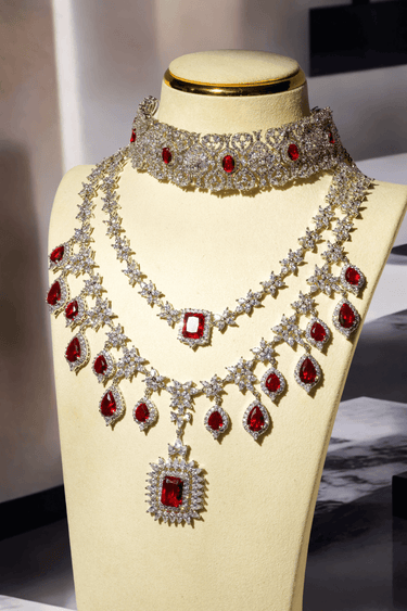 Priya Diamante Bridal Set - Rhodium-plated silver with maroon accents, including cascading necklace and intricate floral choker with matching earrings.