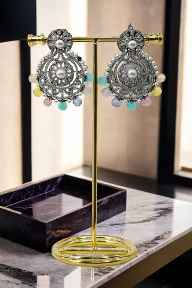 Close-up of Navya Black Plated Chandbali Earrings with pearl center and pastel drops, perfect for traditional occasions and ethnic outfits.