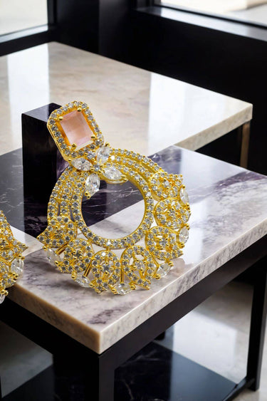 Close-up of The Mia - Dainty Chandbali Earrings with CZ Stones in blush pink, showcasing intricate gold detailing and sparkle.