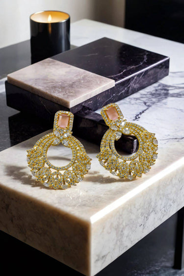 The Mia - Dainty Chandbali Earrings with CZ Stones in gold and blush pink, displayed on a marble surface for a luxurious jewelry look.