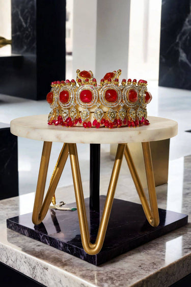 Side view of Sweta Choker Set - Diamante Necklace with bold red gems and intricate detailing on a marble and gold stand.
