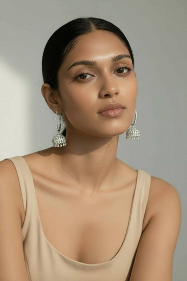 Moden wearing the Inaury Subha modern hoop jhumka earrings in rhodium plating with white AD diamante stones – South Asian fusion jewelry