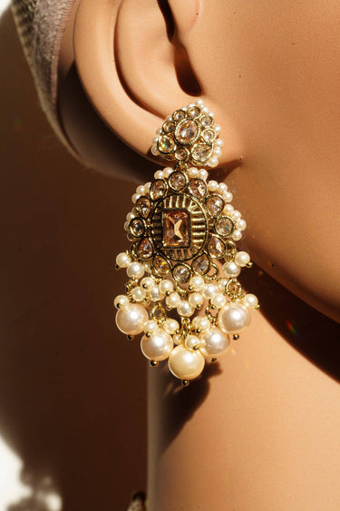 Gold earrings with pearls and intricate design