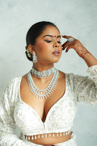 Model wearing Nafisha Silver & AD Stone Choker Set with layered necklaces and earrings, styled for bridal or festive occasions.