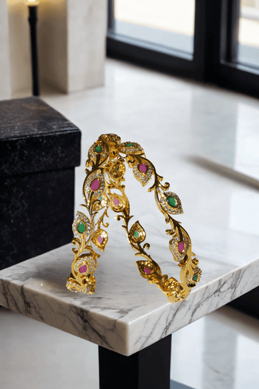 Norea 6-piece gold-plated bangle set with green, ruby, and white stones and intricate floral and vine motifs