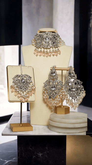Display of Noreen Choker Necklace Set - Elegant Pakistani Bridal Jewels in silver and pink, featuring detailed craftsmanship and bridal elegance.
