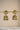 Antique gold jhumka earrings with intricate Nakshi carving, American diamond embellishments, and hanging pearl beads for festive occasions