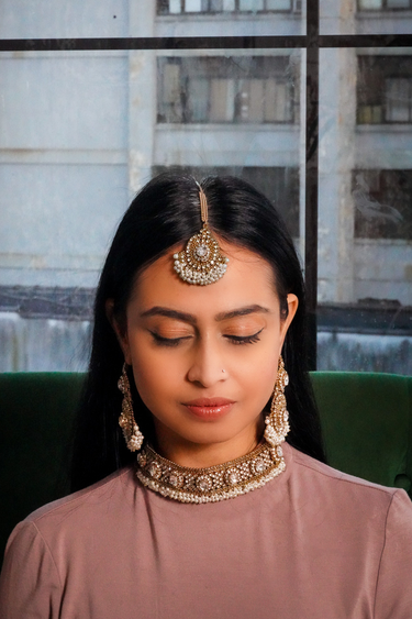 Front view of model wearing Rimmie Artisan Crafted Choker Set, highlighting intricate zircon and pearl embellishments in Pakistani jewelry style.