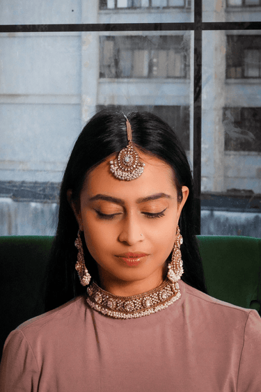 Front view of model wearing Rimmie Artisan Crafted Choker Set, highlighting intricate zircon and pearl embellishments in Pakistani jewelry style.