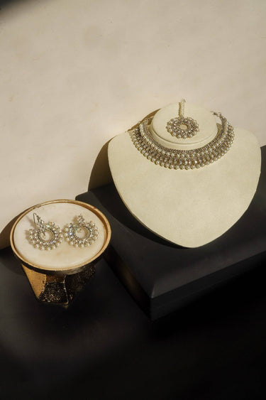 Roza Zircon Choker Set with Maang Tikka displayed on stand