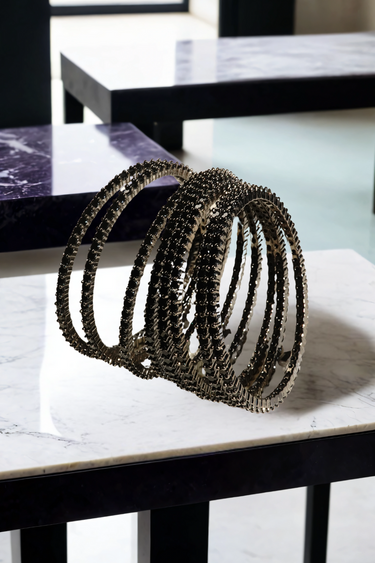Simran Bangles - Set of 8 Choori Style Black Plated Bangles with Black Stones by Inaury, displayed on a marble surface with luxurious black detailing.