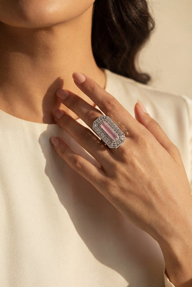 A woman wearing silver-toned adjustable baguette diamante statement ring with blush pink center stone - South Asian jewelry - Inaury
