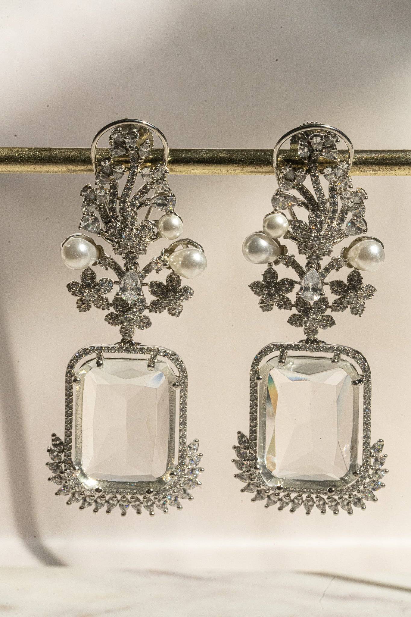 Front view of Aayat Statement Earrings in crystal white with pavé halo, pearl accents, and floral rhodium-plated craftsmanship.