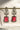 Front view of Aayat Statement Earrings in ruby red with bold gemstone, floral pavé design, and pearl accents. Rhodium-plated danglers.