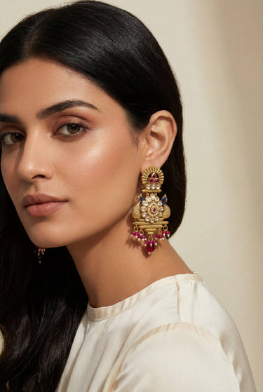 Modern South Asian model wearing Adrita peacock Kundan earrings for a traditional Mehendi celebration.