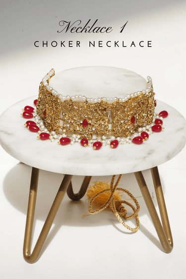 Amreen Gold Plated Red Bridal Set - 5-piece jewelry set with gold plating, white and golden zircon stones, faux pearls, and red beads.
