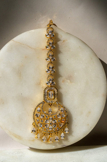 Gold-plated floral maang tikka with American Diamonds in white and pink from Inaury