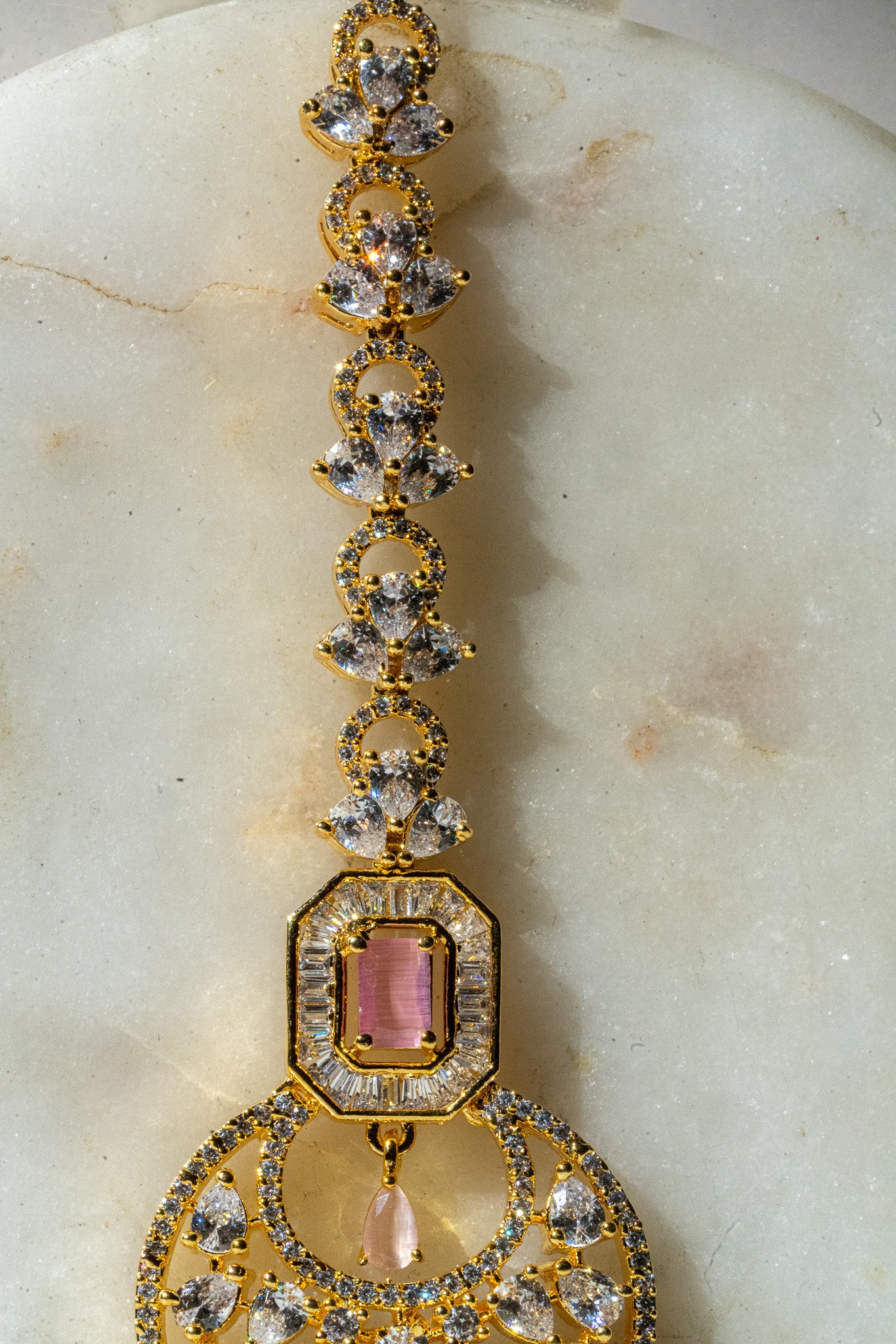 Gold-plated floral maang tikka with American Diamonds in white and pink from Inaury