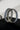 Pair of rhodium plated silver bangles with sapphire blue gemstones on a black surface
