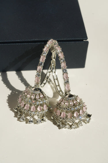 Disha blush pink AD hoop jhumka earrings angled view showing American Diamond teardrop dangles and lattice dome