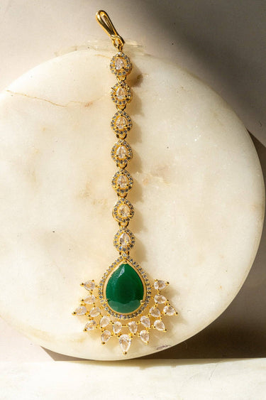 Gold-plated maang tikka with matte green teardrop center and white AD stones from Inaury