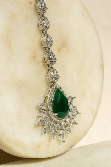 Rhodium-plated maang tikka with matte green teardrop center and white AD stones from Inaury