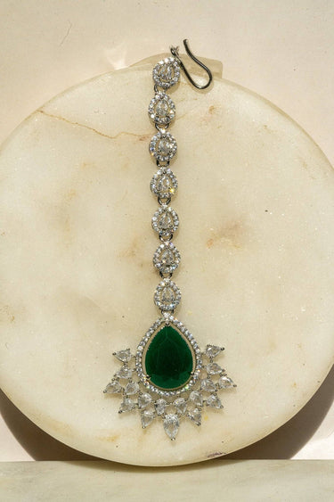 Rhodium-plated maang tikka with matte green teardrop center and white AD stones from Inaury