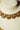 Ishani antique gold necklace detail showing textured crescent motifs, champagne crystals and dangling gold beads