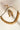 Julie gold-plated crescent wave AD stone necklace and matching earrings laid flat, showing the extender chain.