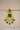 A macro close-up view of a single Kavya statement earring emphasizing the vibrant green color configuration across the centerpiece and droplet fringe.