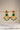 A front e-commerce catalog display showcasing the monochrome emerald green variant of the Kavya gold-plated statement chandbali earrings.