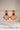 A clean studio catalog display showcasing the all-ruby red colorway variant of the Kavya traditional gold-plated crescent statement earrings.
