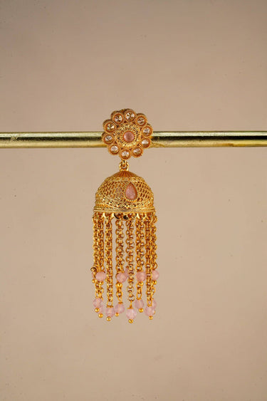 A close up studio product shot of a single Lara handcrafted gold jhumka earring highlighting the floral stud and long cascading bead chains.