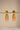 A clean studio view of the reverse side of the Lara gold jhumka earrings on a display bar showing the push back closure and finish quality.