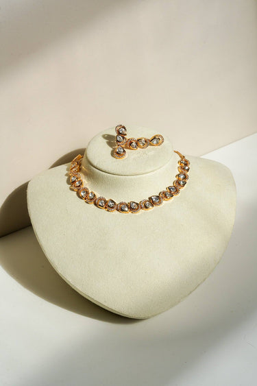 A full studio display shot of the Mehr gold-plated teardrop Moissanite strand necklace and matching triple-drop earrings mounted on a cream showcase bust.