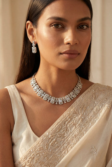 A close-up front view of a model showcasing the intricate emerald and baguette crystal pattern of the rhodium-plated Shanaya choker necklace.