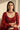 A face-on model portrait styling the Sweta red doublet and polki choker necklace set with a dark formal outfit for an elegant look.