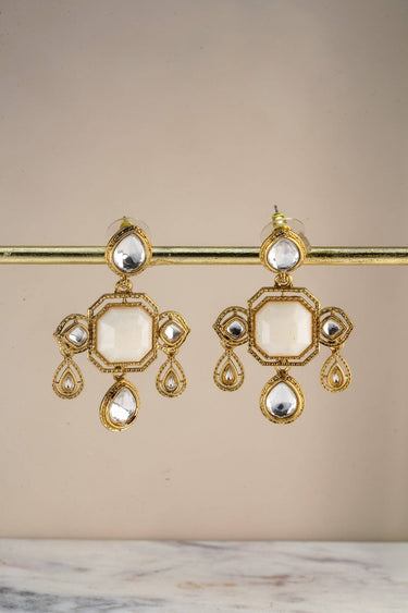 A crisp front studio view of the pair of Zoe mehndi gold drop earrings showcasing the symmetrical layout of crystals on a display bar.