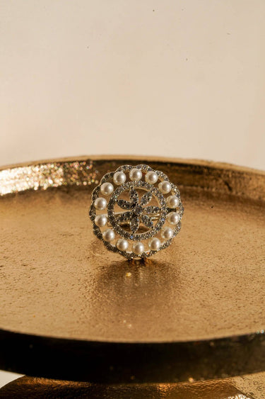 Asal rhodium plated pearl dome ring front view on gold tray with AD stones and pearl border Inaury