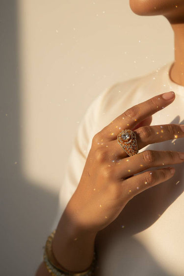 Darya gold plated AD crown ring on hand with sparkling light reflections showing marquise stone detail Inaury