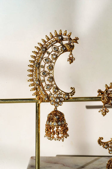 Inaury Maharani Ear Cuff with Jhumka Pearl White close-up — intricate filigree work with AD stones and peacock crown detail on gold-plated brass